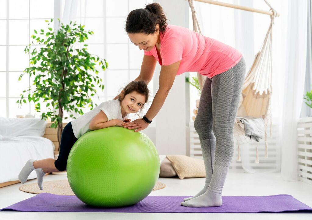 kid woman training with gym ball